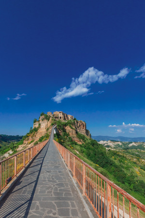 Footbridge leading to Civita di Bagnoregio the dying city in Italy.の写真素材