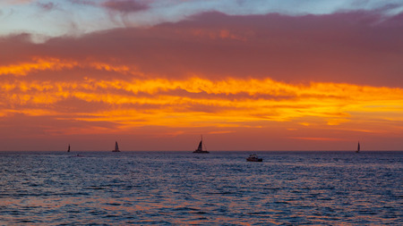 View of sail boats traveling in the sea under sunset, in Key West, Florida, USAの写真素材