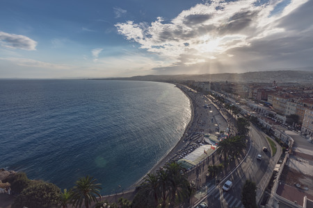 View of the Promenade des Anglais and city of Nice, France, by the sea, from Castle Hill, against the sunlightの写真素材