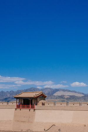 Fortress wall and traditional pavilion, under blue sky at Jiayu Pass, first frontier fortress at the west end of the Ming dynasty Great Wall of China, in Jiayuguan, Chinaのeditorial素材