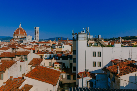 View of the Florence Cathedral and Giotto's Bell Tower under blue sky, over houses of the historical center of Florence, Italyの写真素材