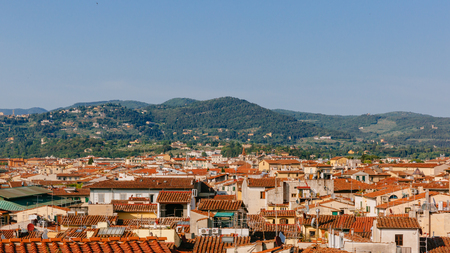 View of houses and architecture of historical center of Florence, Italy under hills and skyのeditorial素材