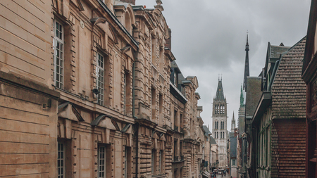 View of the Tower of Saint-Germain of the Rouen Cathedral between buildings, in the city center of Rouen, Franceの写真素材