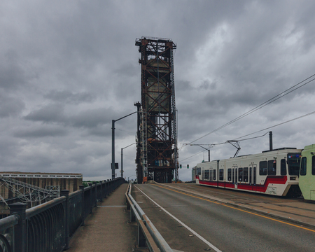View of Steel Bridge over Willamette River with tram in downtown Portland, USAの写真素材