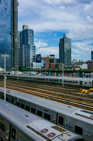 New York City, USA - June 24, 2018: View of trains and tracks in Hudson Yard and skyscrapers of...