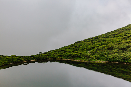 View of Xima Pool (Pool of Horse Washing) under clouds on top of Mount Cangshan, in Dali, Yunnan, Chinaの写真素材