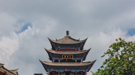 View of traditional Chinese gate tower building in old town of Dali under sky and clouds, in Dali, Yunnan, Chinaのeditorial素材