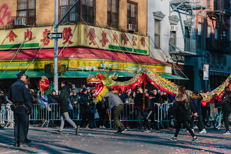 New York City, USA - Feb. 17, 2019: A dragon dance team traveling in the Lunar New Year parade in Chinatown, Manhattanのeditorial素材