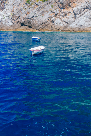 View of boats over blue water in a cove near the town of Praiano, along the Amalfi Coast, Italyの写真素材