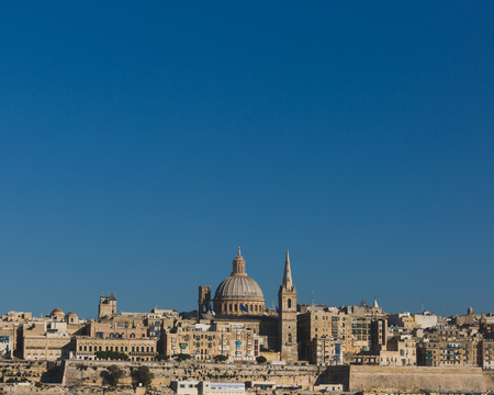 View of skyline of Valletta, Malta under blue sky, with dome of Basilica of Our Lady of Mount Carmel and tower of St Paul's Pro-Cathedralのeditorial素材