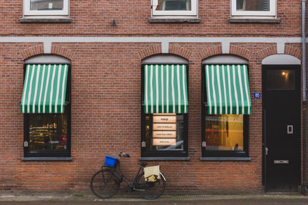 Amsterdam, the Netherlands - March 4, 2017: Bike parked by shop windows in downtown Amsterdam