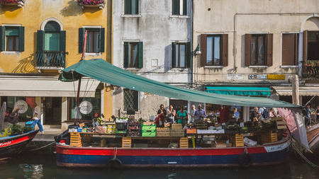 Venice, Italy - June 6, 2017: People buying groceries from a grocer on a boatのeditorial素材
