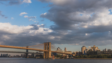 Brooklyn and Manhattan bridge over East River at dusk with skyline of Brooklyn, viewed from lower Manhattan, New York, USAのeditorial素材