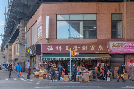 New York City, USA - Feb. 26, 2019: Intersection of Forsyth Street and East Broadway in Chinatown, with pedestrians waiting to cross streetのeditorial素材