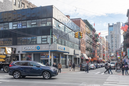 New York City, USA - Feb. 26, 2019: Intersection of Mott and Canal street in Chinatown, with cars and pedestrians walking, and Chase Bankのeditorial素材