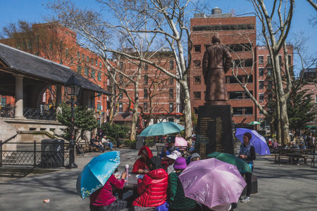 April 13, 2019 - New York City, USA: Locals palying poker games in Columbus Park in Manhattan...