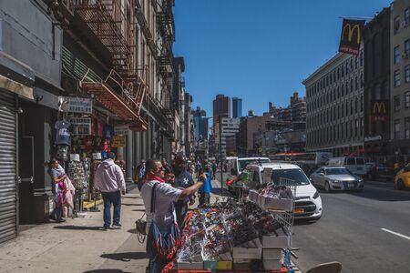 April 16, 2019 - New York City, USA: People buying sunglasses from street vendor in Manhattan Chinatownのeditorial素材