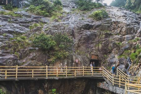 May 18, 2019 - Yichun,Jiangxi, China: Tourists taking photos at entrance of Xingyue Cave on top of Mingyue Mountainのeditorial素材