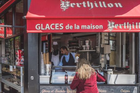 June 14, 2019 - Paris, France: Woman buying ice cream at ice cream shop in downtown Parisのeditorial素材