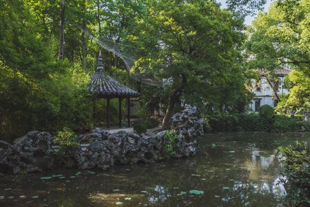 Pavilion among trees in by water in the old town of Nanxun, Zhejiang, Chinaの写真素材