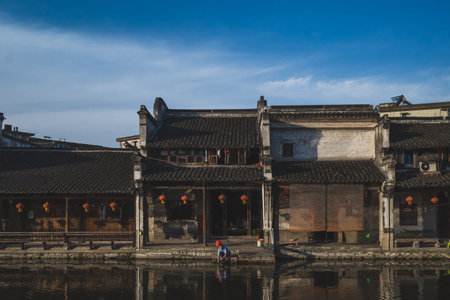 Nanxun, Zhejiang, China - 24 May 2019: Local man washing clothes in river in Nanxun Old Townのeditorial素材