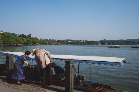 22 May 2019 - Hangzhou, China: People crossing street at intersection of Wulin Road and Fengqi Roadのeditorial素材