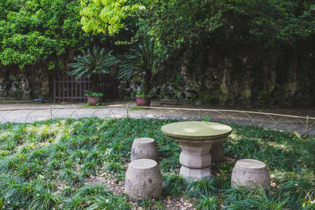 Stone table and stools in garden in city centre of Shaoxing, Chinaの写真素材