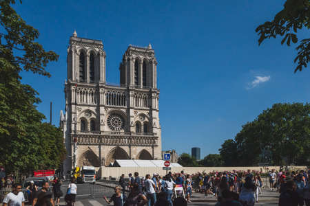 Paris, France - July 2, 2019: People walking in front of Notre-Dame de Paris Cathedral, which is under construction after the 2019 fireのeditorial素材