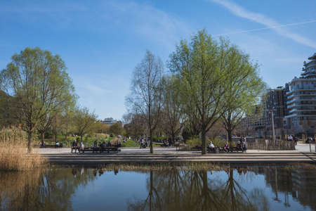 Paris, France - March 29, 2021: Locals enjoying a sunny afternoon outside in Martin-Luther-King Park in 17th arrondissementのeditorial素材