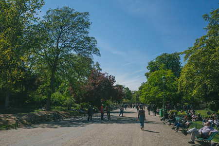Paris, France - April 25, 2021: Locals enjoying a sunny afternoon outside in Monceau Park during the third national lockdownのeditorial素材