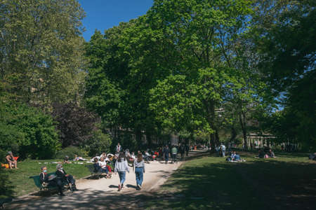 Paris, France - April 25, 2021: Locals enjoying a sunny afternoon outside in Monceau Park during the third national lockdownのeditorial素材