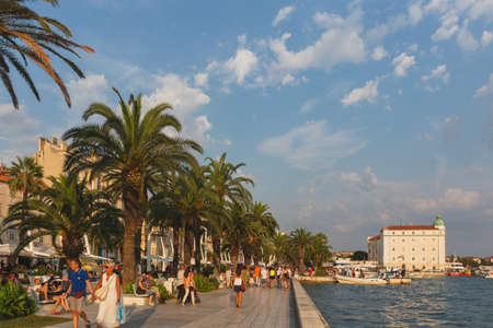 Split, Croatia - August 11, 2015: People walking along the Riva promenade at duskのeditorial素材
