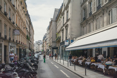 Paris, France - June 23, 2019: Pedestrians and restuarant on Rue de Temple in 4th arrondissement