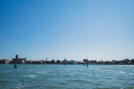 View of island and lagoon under blue sky in Venice, Italyの写真素材