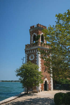 Tower of Arsenal by water in Venice, Italyの写真素材