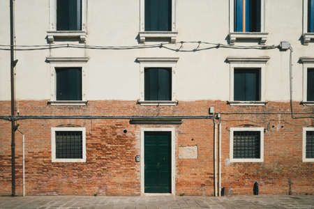 Wall with door and windows of a traditional Venetian houses in Venice, Italyのeditorial素材