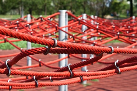 Kids climbing frame in a public park on a sunny dayの写真素材