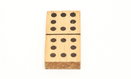 Single wooden domino on isolated white background