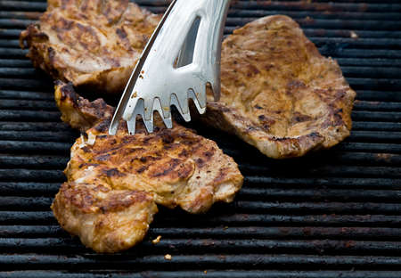 Pork chops meat cooking on barbecue grill
