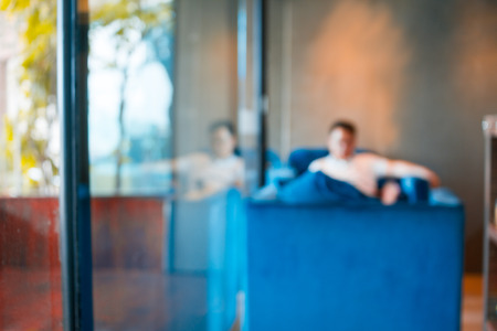 blur bokeh copy space background men sit drinking coffee in the shop. Business students drink coffee and relax in the coffee shop.の写真素材