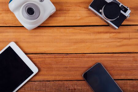 Creative flat lay photo of workspace desk with camera tablet on wood tableの写真素材