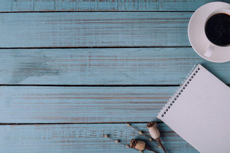 notebook office desk on blue wooden table backgroundの写真素材