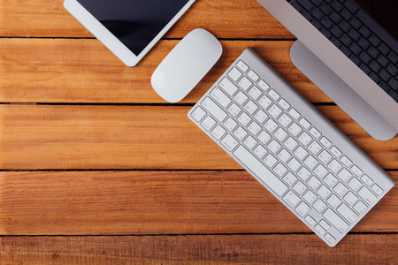 Creative flat lay photo of workspace desk with tablet on wood tableの写真素材