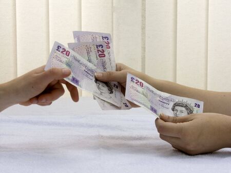 Passing money between two hands.の写真素材