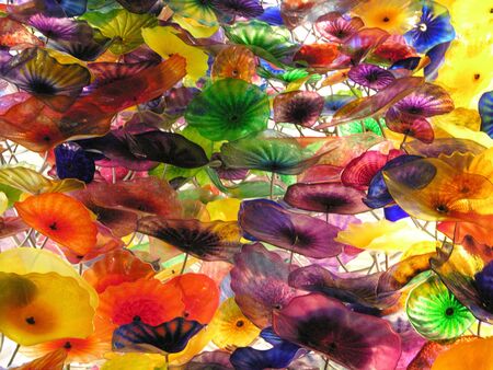 An abstract shot of some colourful ornate glass flowersの写真素材
