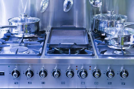 A new gas hob tinted blue with saucepansの写真素材