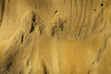 An abstract pattern of layers of sand which would create a good background texture.