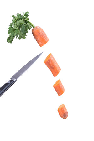 carrots and knife. Metal knife cuts carrotsの写真素材