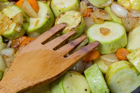 Stewed zucchini and spices. Wooden fork.の写真素材