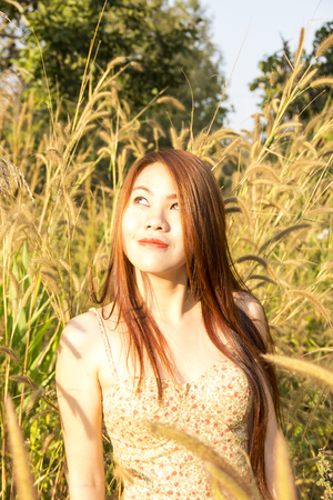 Asian girl in a field of flowersの写真素材